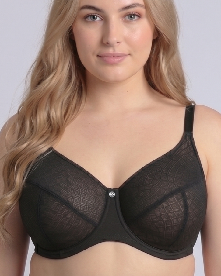 Close-up front portrait of a plus-size model wearing the NewG Bella black underwire minimizer bra for large busts, highlighting the intricate geometric mesh pattern, central jewel detail, and supportive full-cup design.