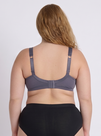 Woman wearing a purple-grey supportive bra for large bust back view
