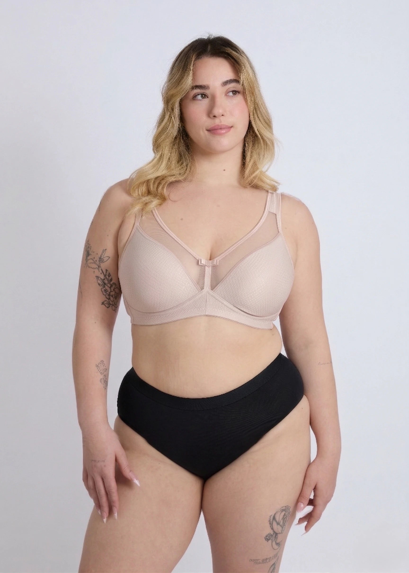 Model showcasing a comfortable beige supportive bra for large bust