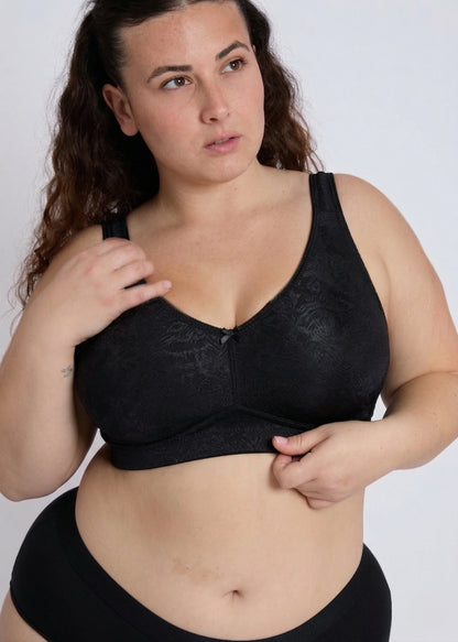 Model posing in a black supportive bra for large bust front view
