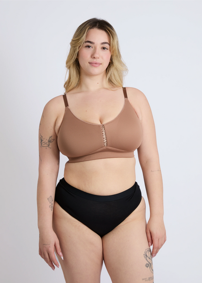Front view of the mocha brown Joy seamless wire-free bra for large breasts on a blonde plus-size model, showcasing the smooth, seamless design for an invisible look under clothes and full support