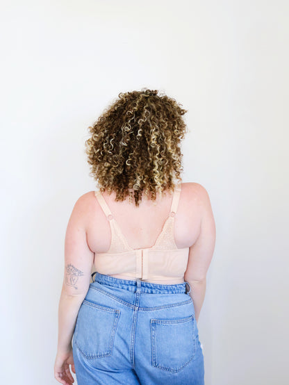 Back view of the nude (peach-toned) Mia wire-free lace bra for large breasts, showing wide adjustable straps and back closure