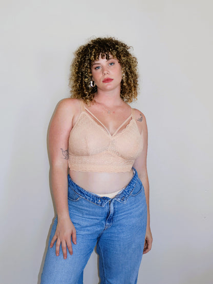 Front view of the nude (peach-toned) Mia wire-free lace bra for large breasts on a model, showing front strap details and a comfortable fit