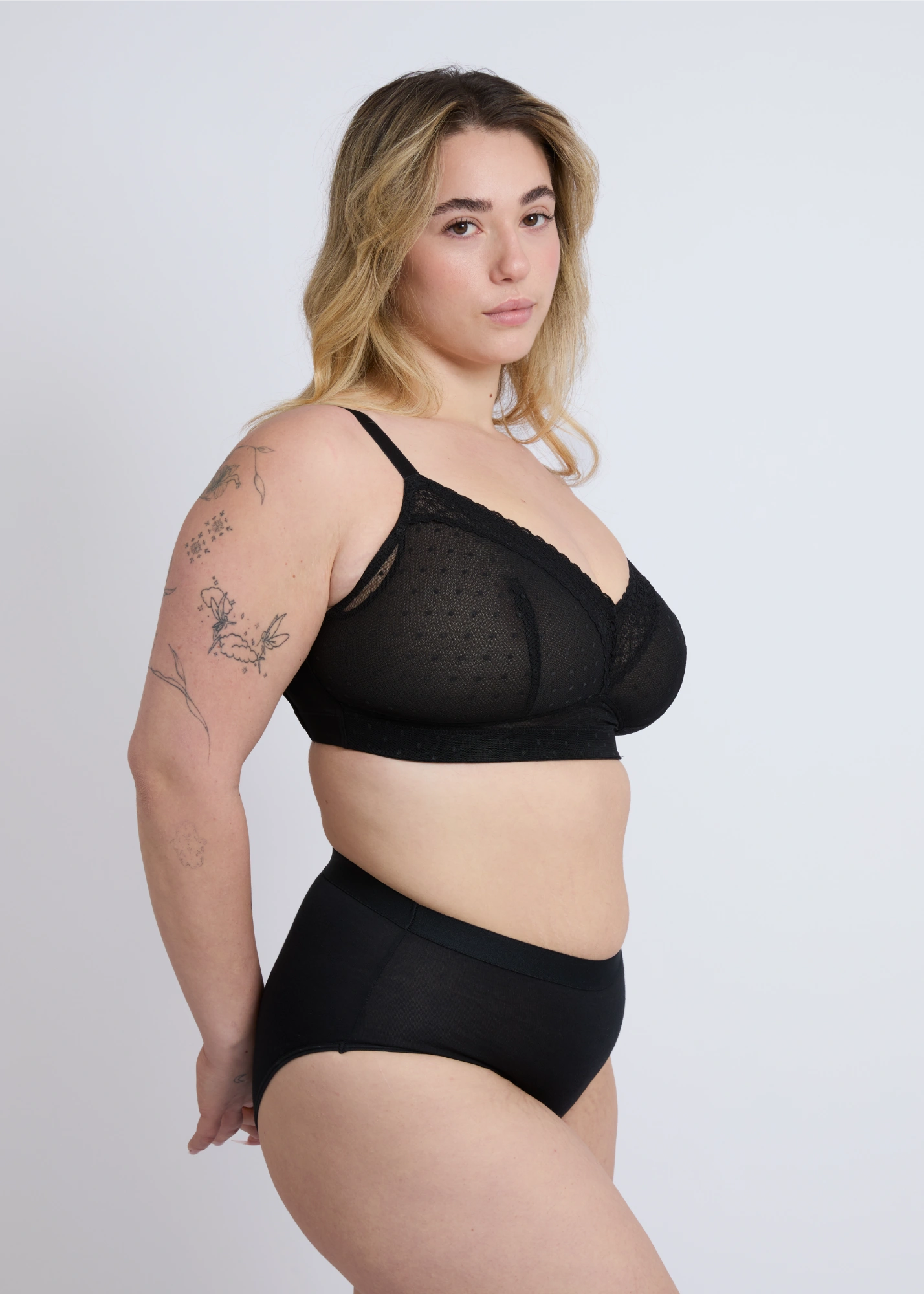Side profile view of the NewG Alma black wireless bra for large busts, showing the lace trim detailing and smooth side support for a comfortable fit.