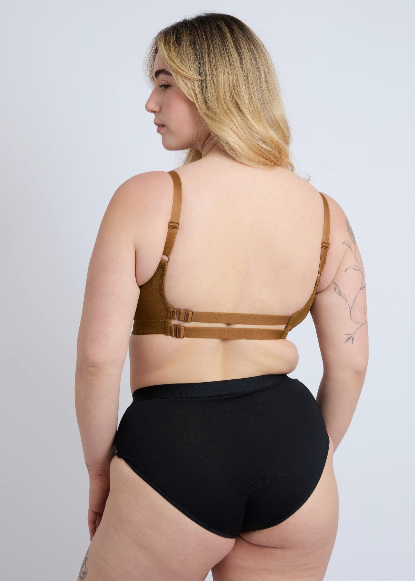 Rear view of the NewG Alma bronze lace wireless bra for large busts, highlighting the adjustable double back strap design and comfortable support on a plus-size model.