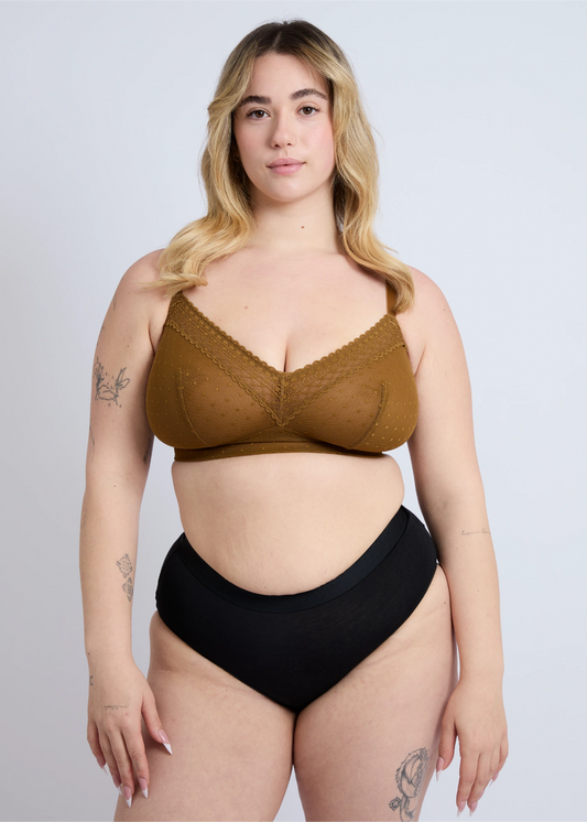 Front view of the NewG Alma bronze lace wireless bra for large busts, featuring a hidden prosthesis pocket and open back design, modeled by a plus-size woman