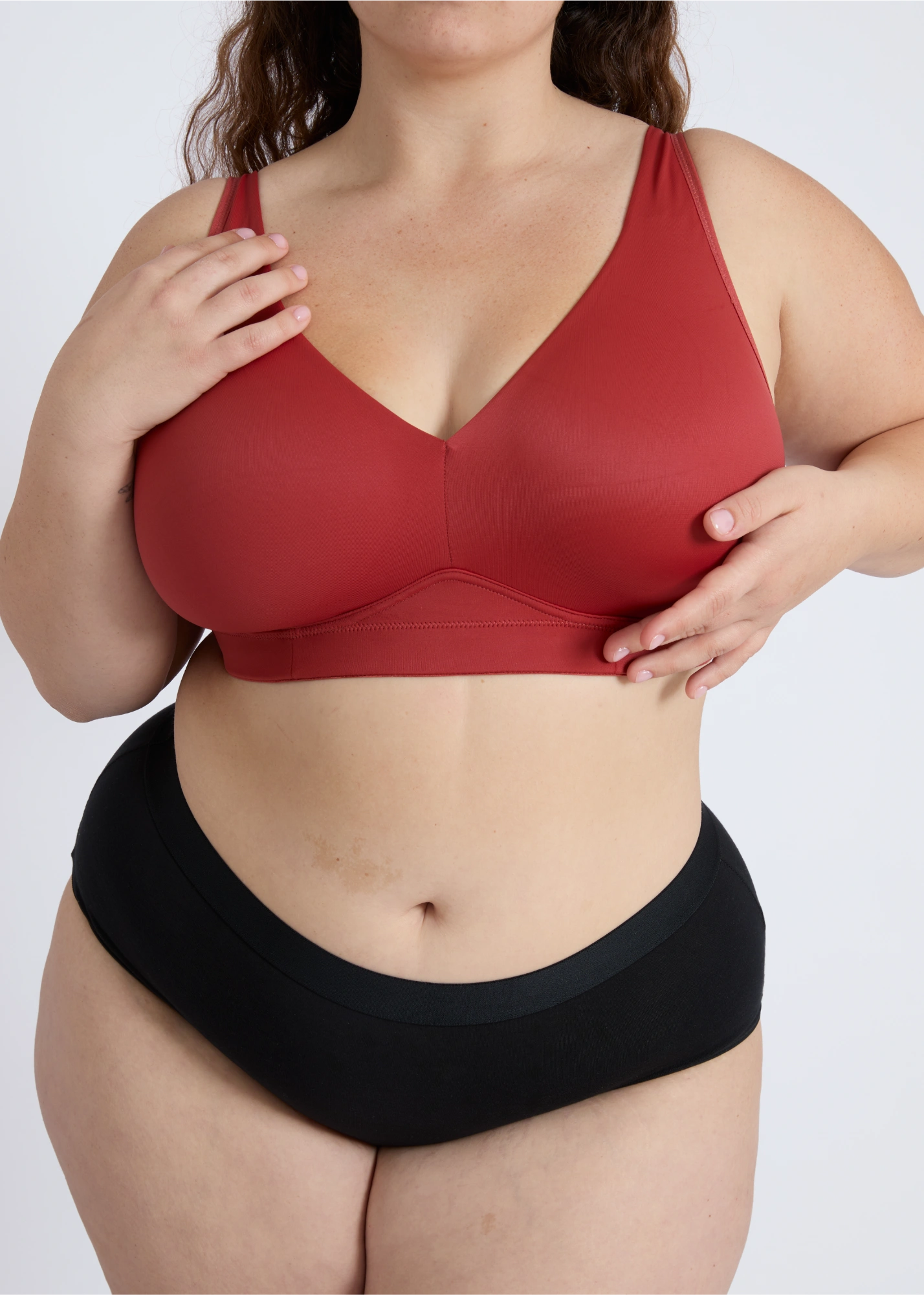 Close-up front view of NewG Doni red wireless bra for large busts, demonstrating comfortable support and a seamless fit on a plus-size model.