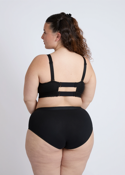 The beautiful low open back design of a black nursing bra for large breasts providing style and freedom
