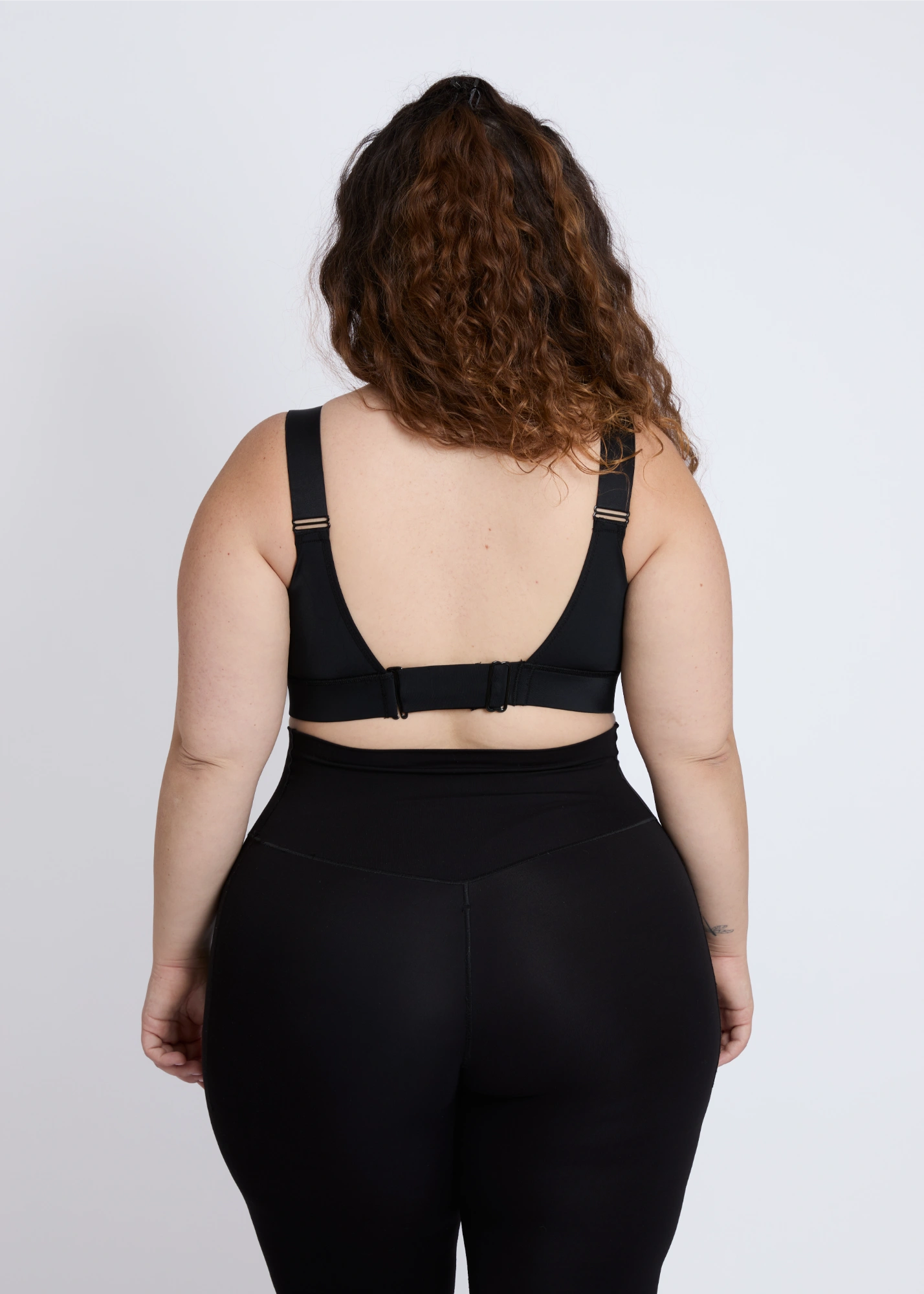 The back design of a supportive black sports bra for big breasts ensuring comfort during workout