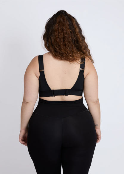 The back design of a supportive black sports bra for big breasts ensuring comfort during workout