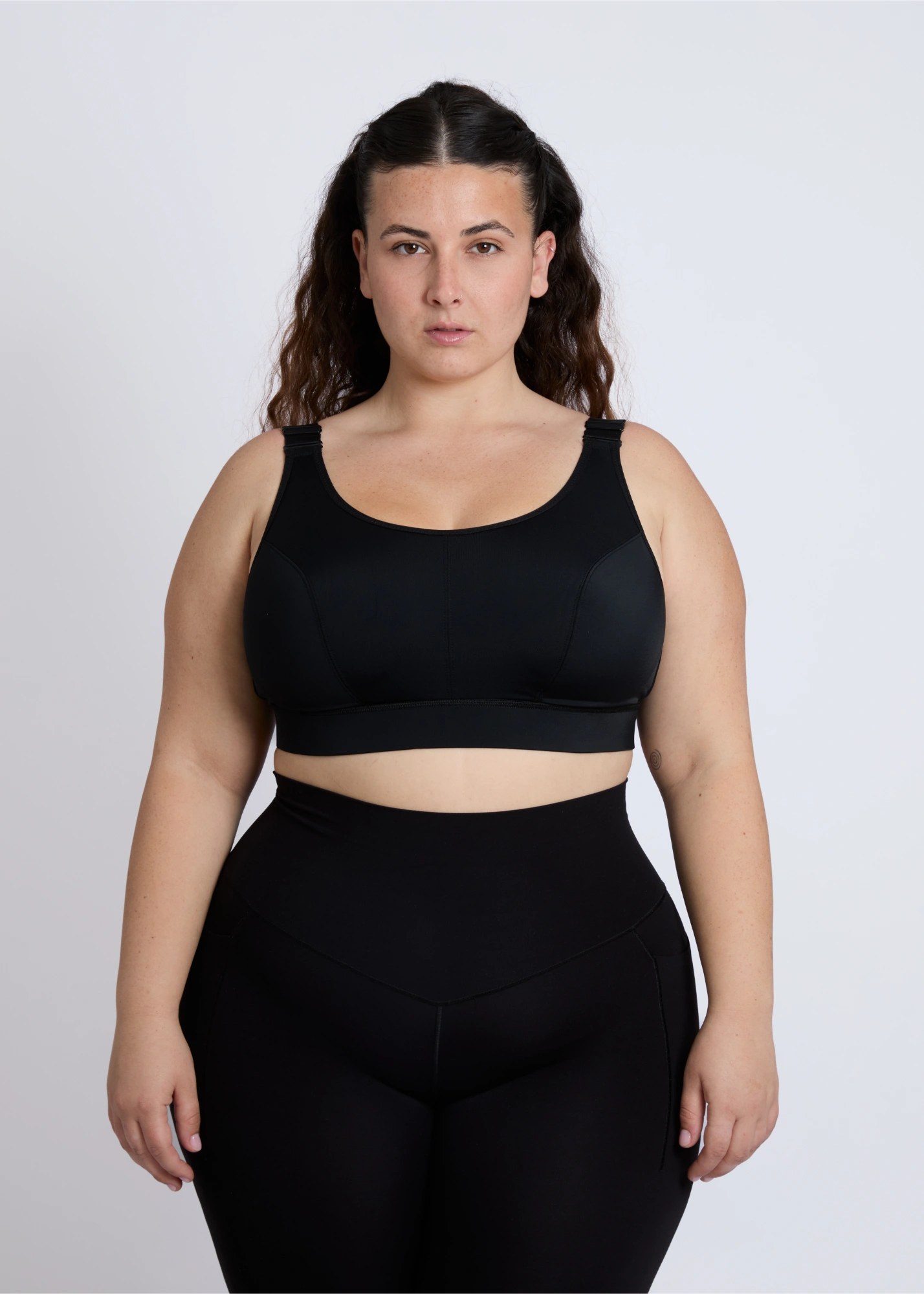 Front view of a supportive black sports bra for big breasts offering high-impact control