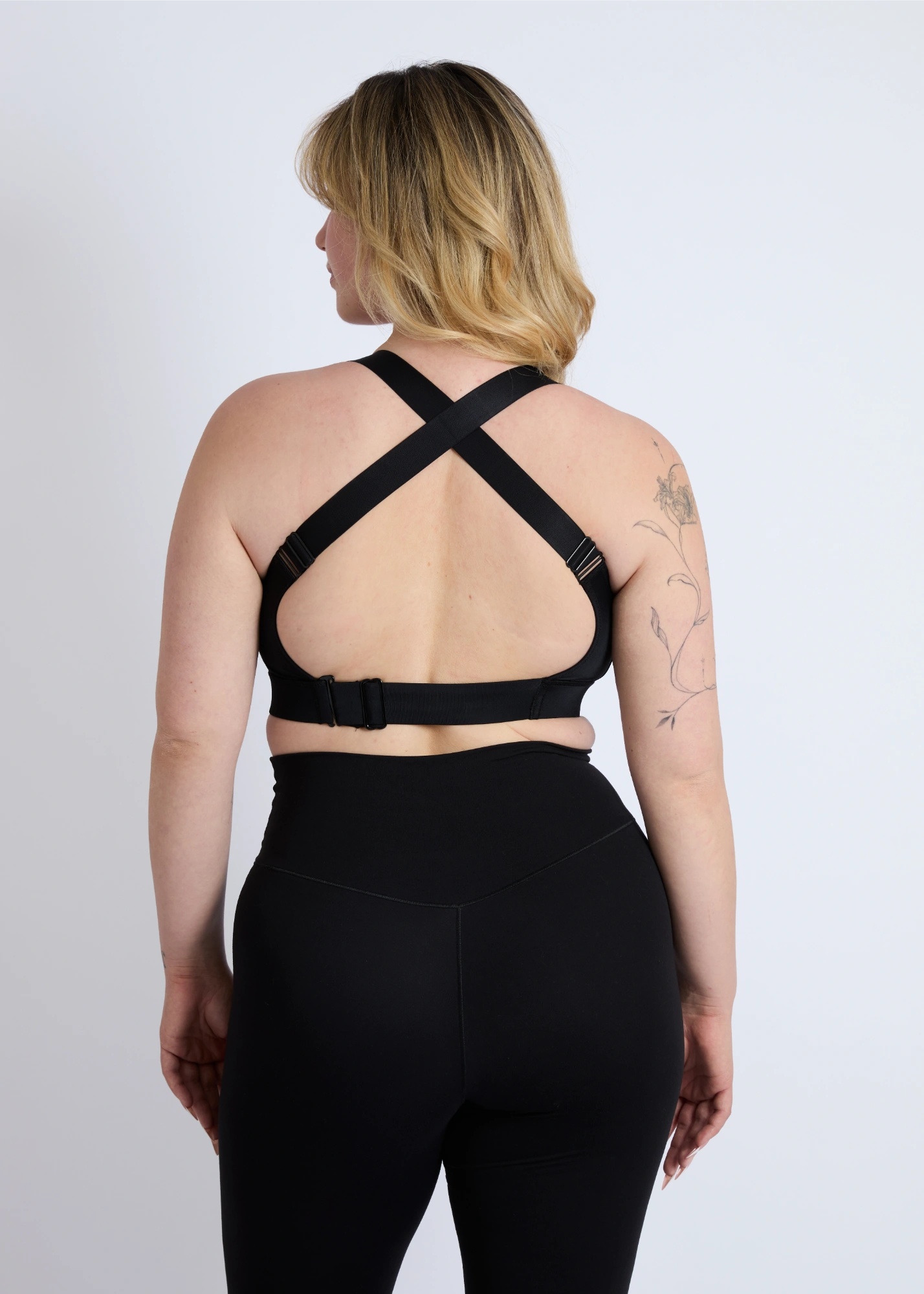 The back view of a black high-impact sports bra for large breasts showing the supportive criss-cross strap design