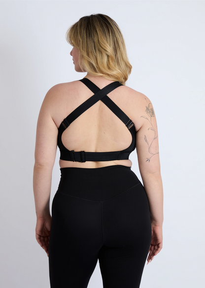 The back view of a black high-impact sports bra for large breasts showing the supportive criss-cross strap design