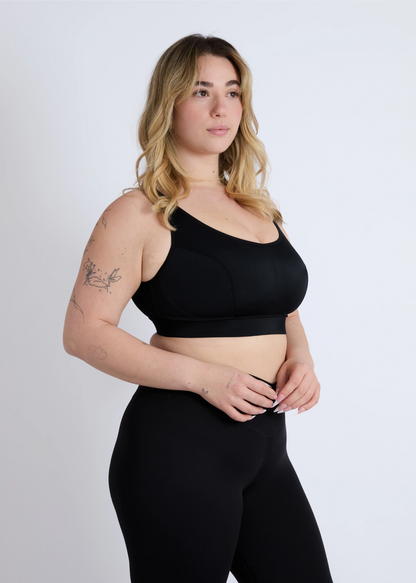 Side view of a black high-impact sports bra for large breasts showing full coverage and side support