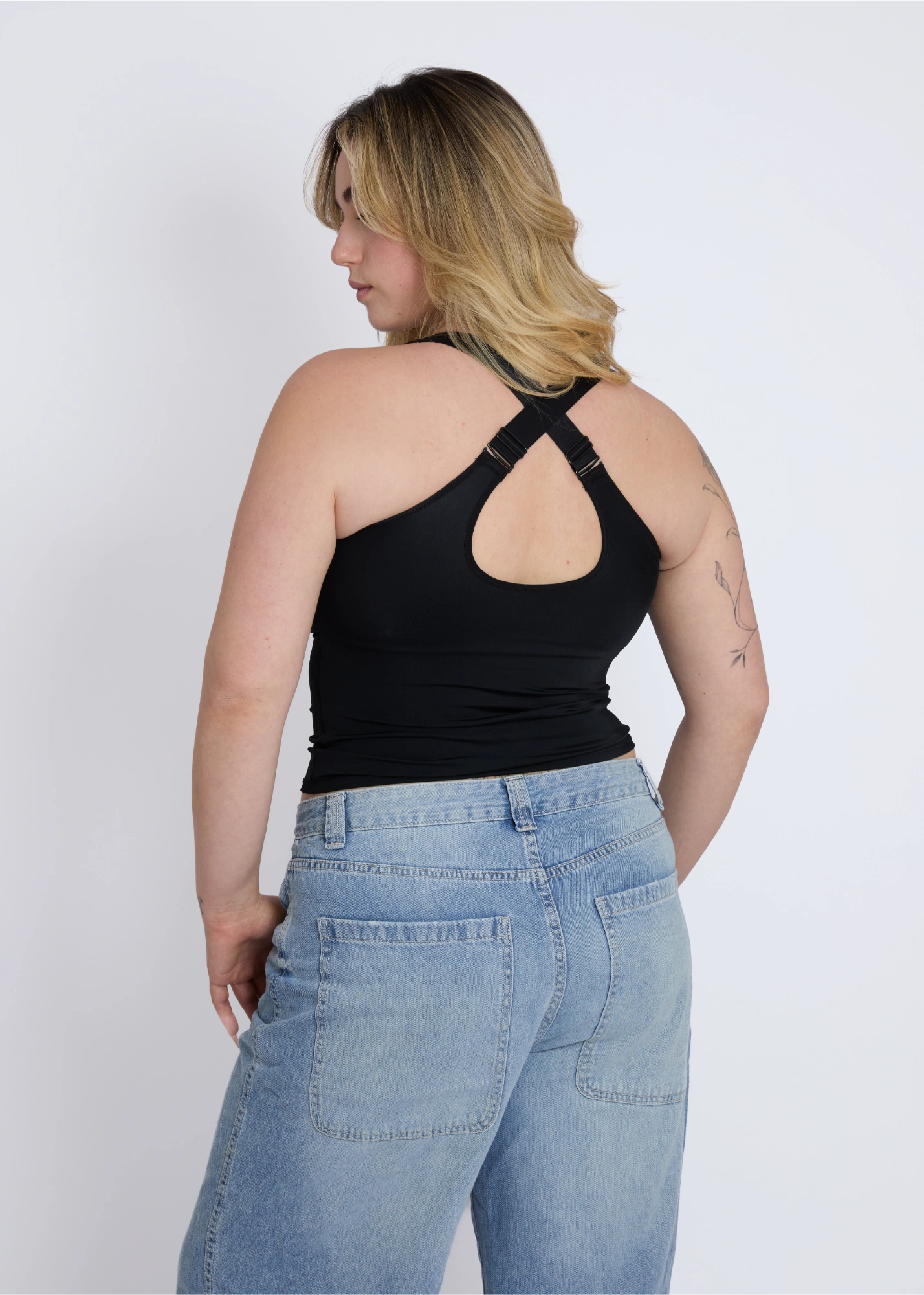 Back view of a black supportive tank top for large breasts featuring a stylish and functional cross-back built-in bra design