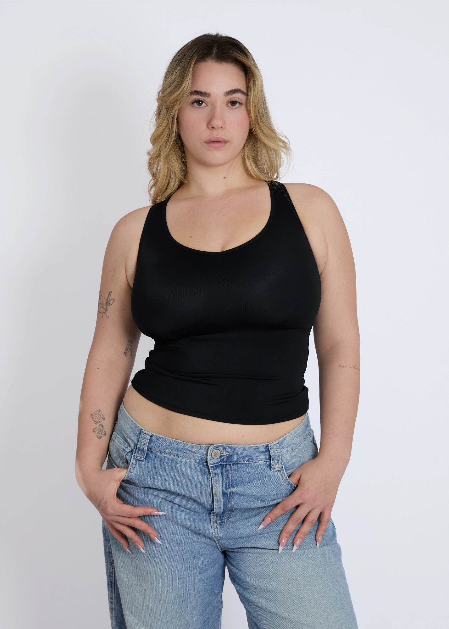 Front view of a black supportive tank top for large breasts with a built-in shelf bra for everyday comfort