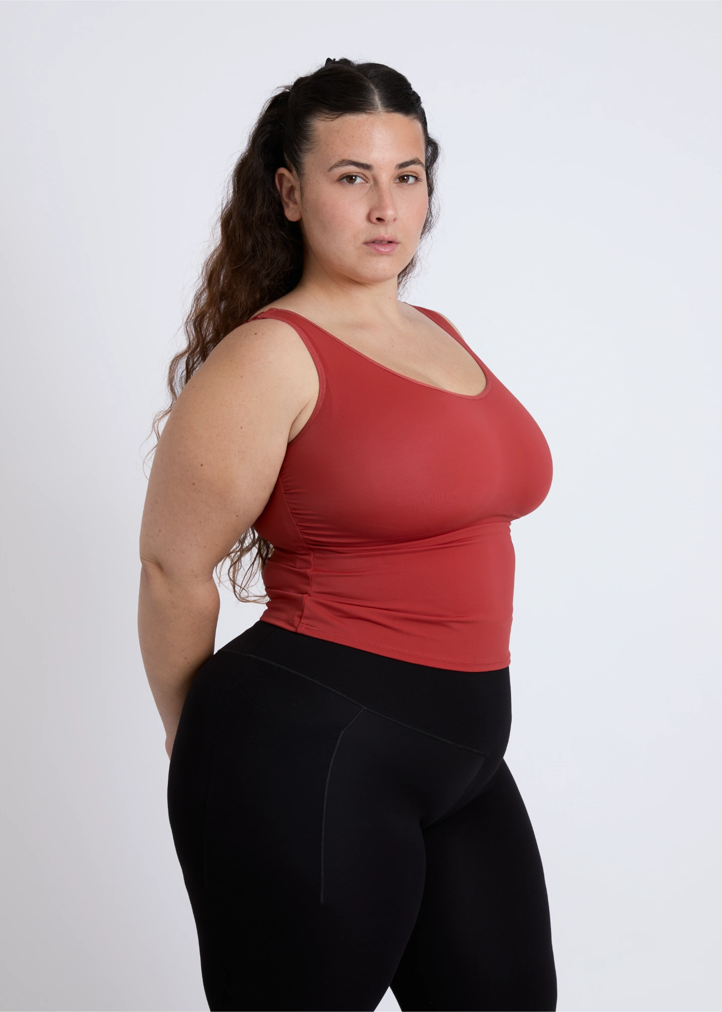 Side profile of a supportive tank top for large breasts with a built-in bra showing a smooth contoured fit